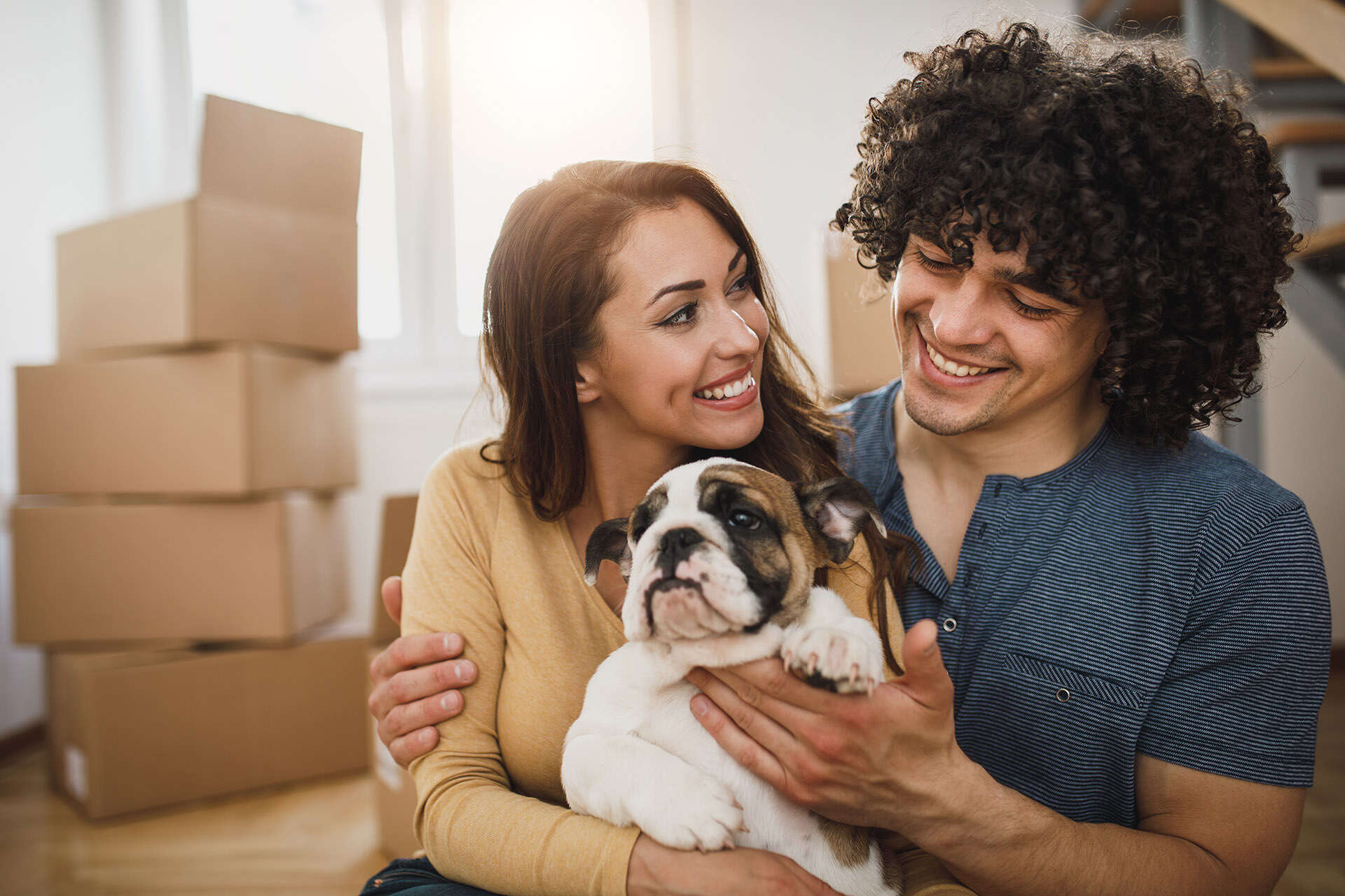 Young couple holding puppy