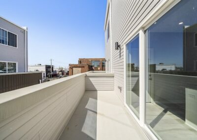 Balcony view of the Port Richmond, Philadelphia area with sliding glass doors to apartment