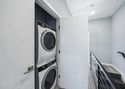 Stacked in-unit washer and dryer on the second floor of a East Tioga Loft residence